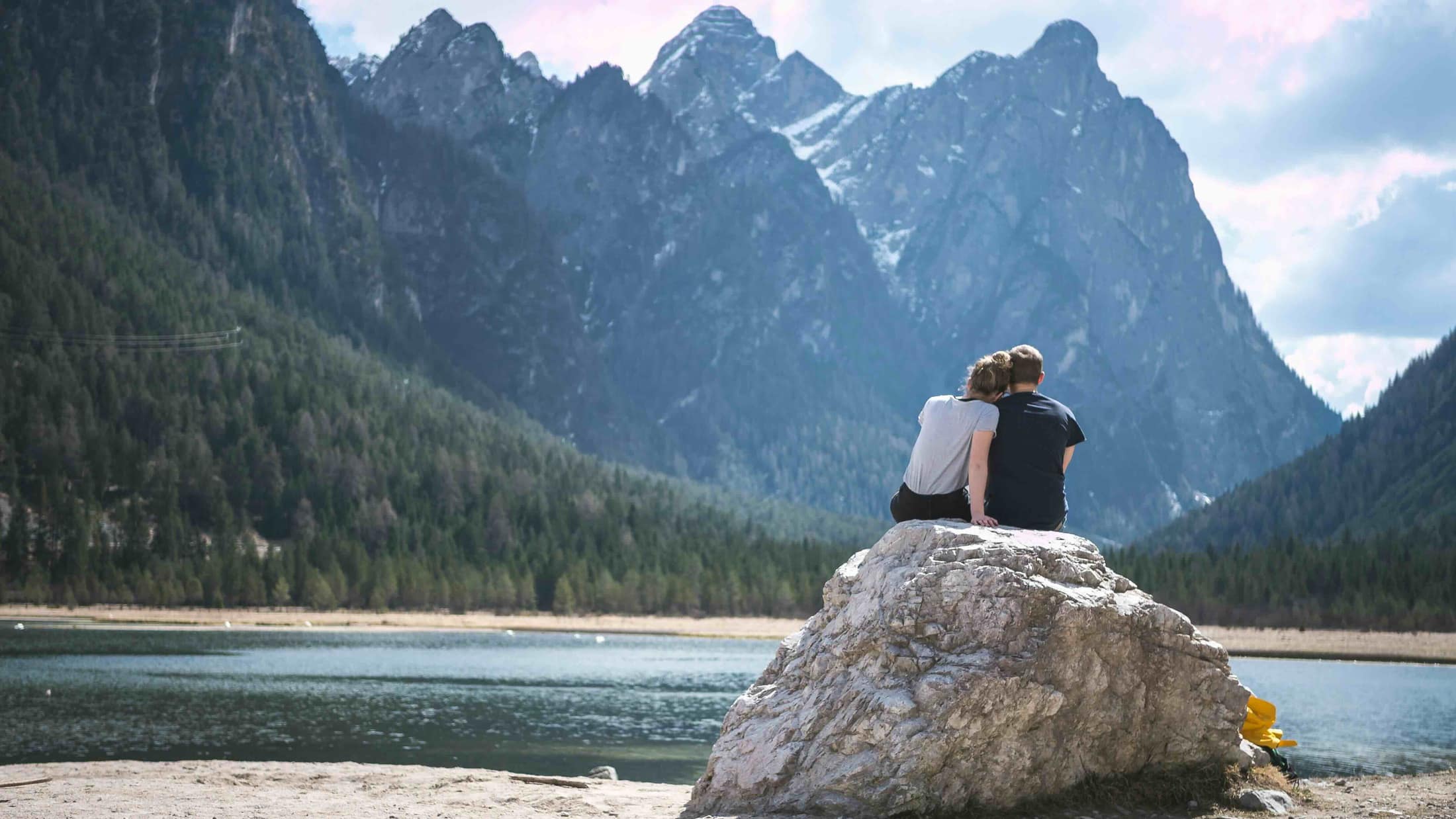 A couple overlooking an alpine lake